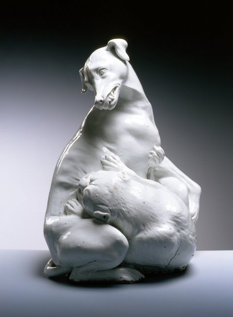 White porcelain sculpture of a bulldog and a wind chime fighting