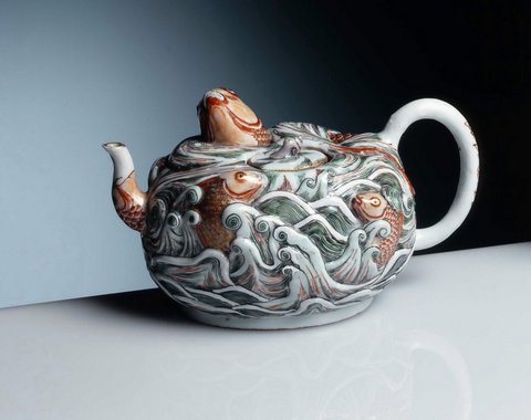 teapot with golden carp looking out of the floods