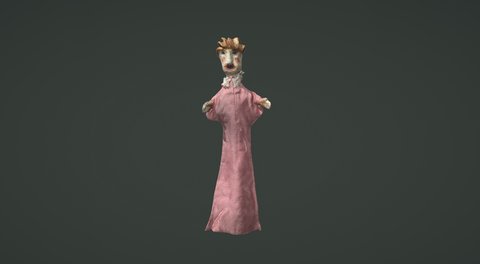 A hand puppet with short, ginger hair in a pink dress.